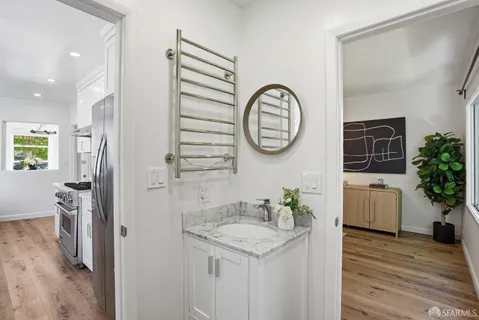 a bathroom with a granite countertop sink and a mirror