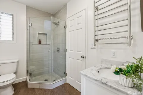 a bathroom with a sink a toilet and shower