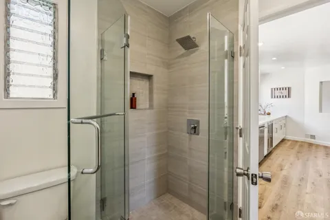 a bathroom with a sink mirror and a toilet