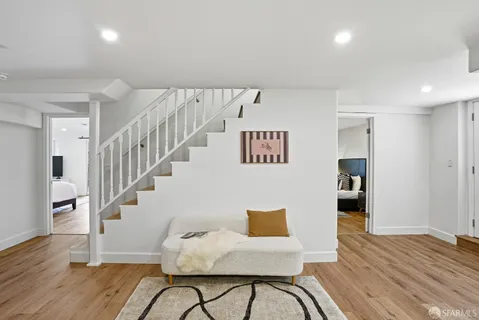 a view of entryway with wooden floor and stairs