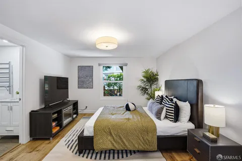 a bedroom with a bed and a flat screen tv