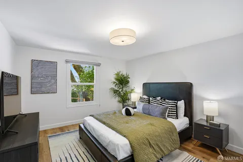 a bedroom with a bed and a flat screen tv