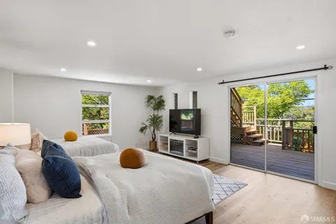 a bedroom with furniture and a flat screen tv