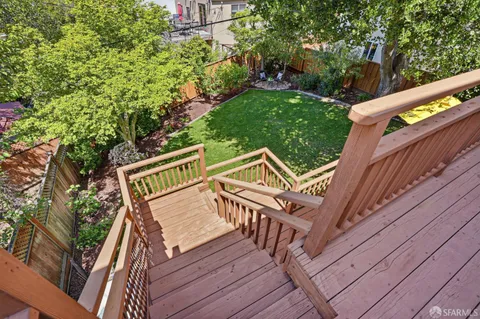 a view of a house with backyard and deck