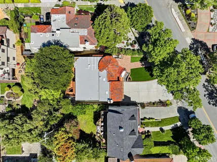an aerial view of a house with a yard and trees