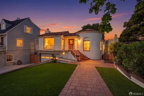 a front view of a house with a garden