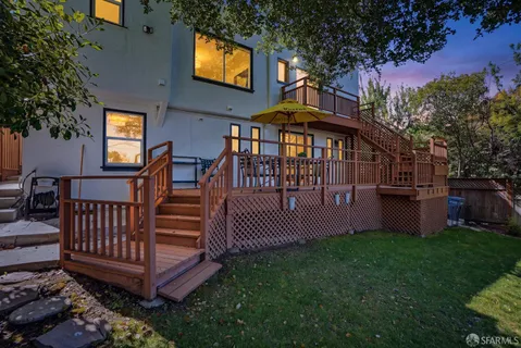 a view of a chairs and table in the backyard
