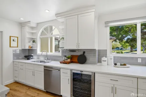 a kitchen with a sink cabinets and window