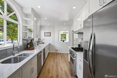 a kitchen with sink cabinets and stainless steel appliances