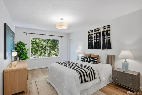 a bedroom with a bed and a lamp on table