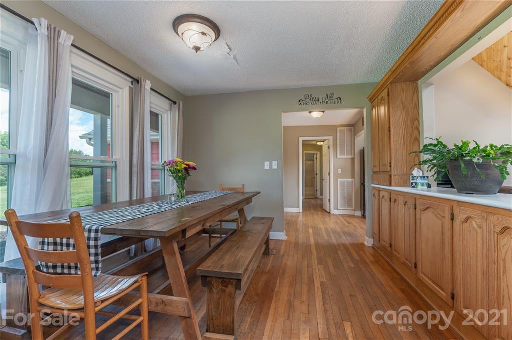 606 Old Stonecutter Road Rutherfordton, NC 28139 - Photo 15 of 48 a view of a dining room with furniture and wooden floor