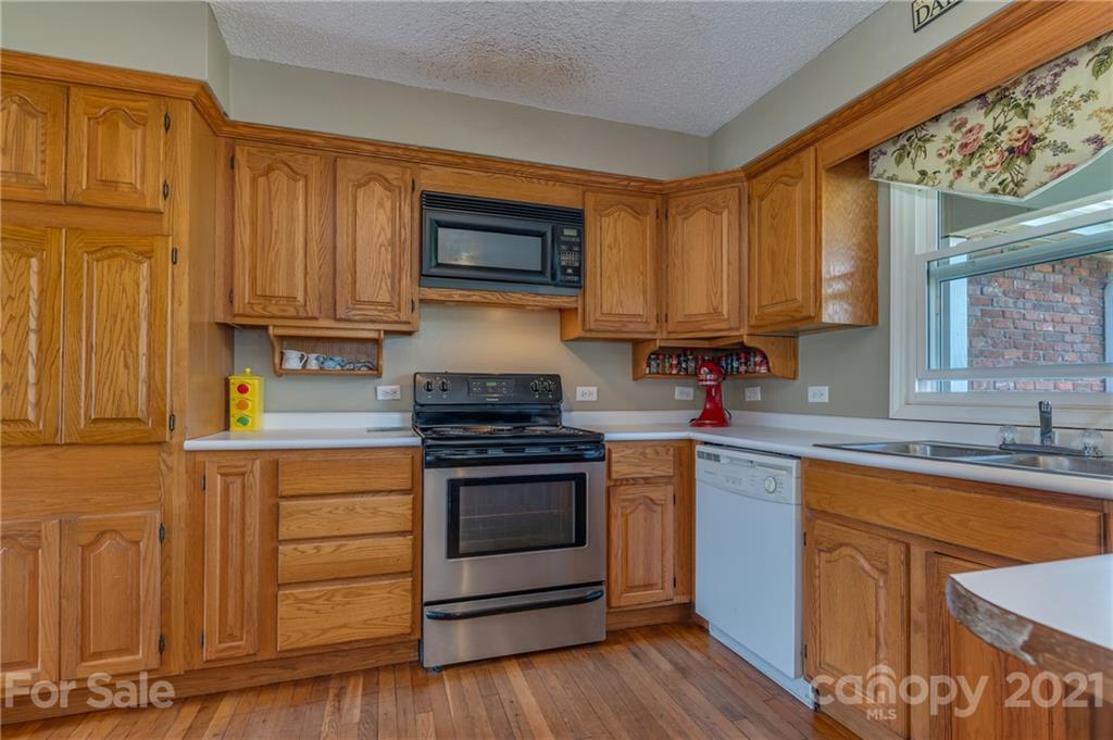 606 Old Stonecutter Road Rutherfordton, NC 28139 - Photo 17 of 48 a kitchen with granite countertop wooden cabinets stainless steel appliances and a window