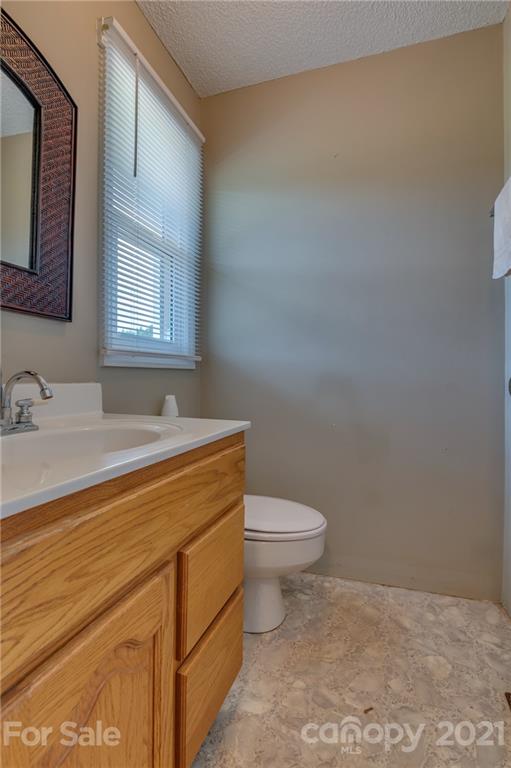 606 Old Stonecutter Road Rutherfordton, NC 28139 - Photo 19 of 48 a bathroom with a sink a toilet and mirror