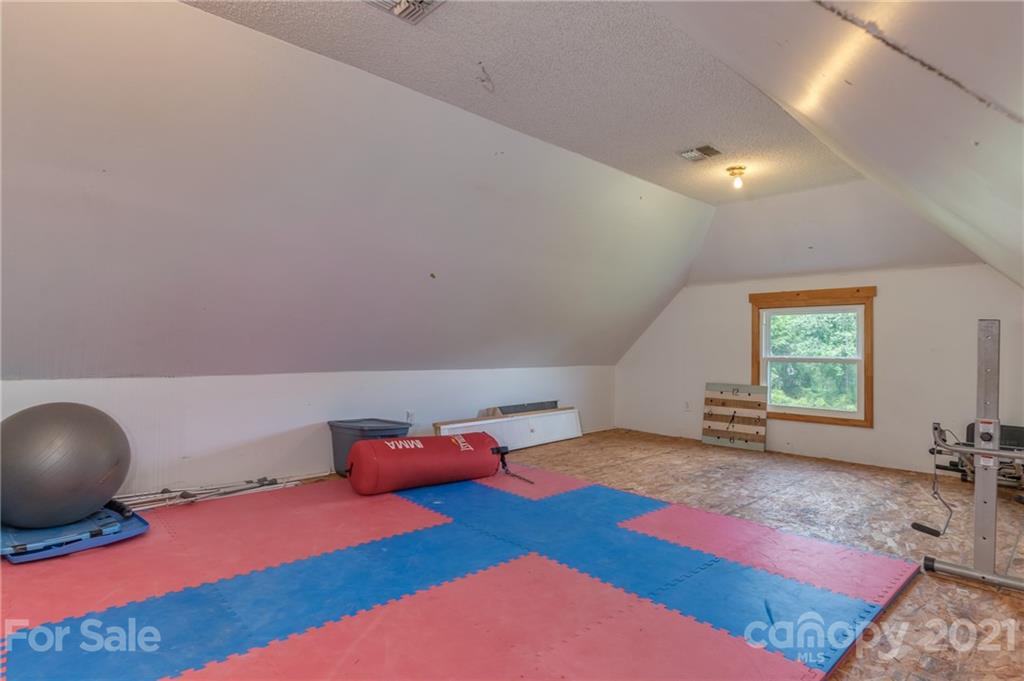 606 Old Stonecutter Road Rutherfordton, NC 28139 - Photo 30 of 48 a bedroom with a bed and a large window
