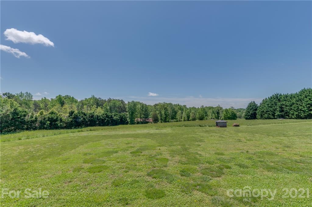 606 Old Stonecutter Road Rutherfordton, NC 28139 - Photo 4 of 48 a view of a grassy field with trees in the background