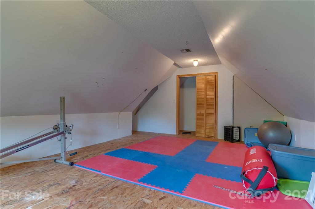 606 Old Stonecutter Road Rutherfordton, NC 28139 - Photo 31 of 48 a bedroom with a bed and a chandelier