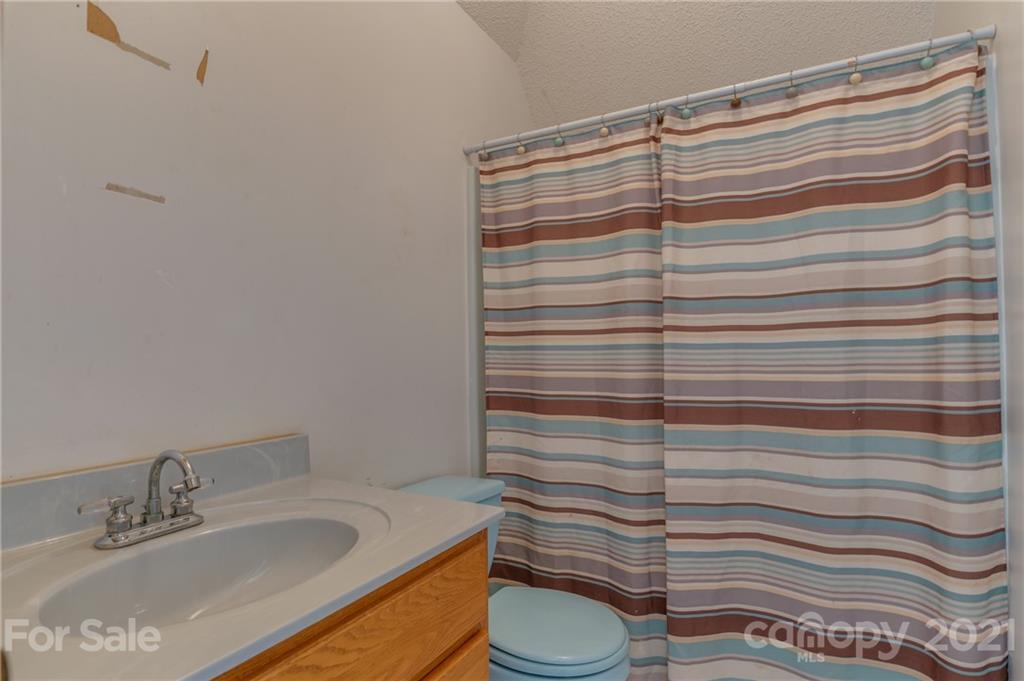 606 Old Stonecutter Road Rutherfordton, NC 28139 - Photo 32 of 48 a bathroom with a sink toilet and shower