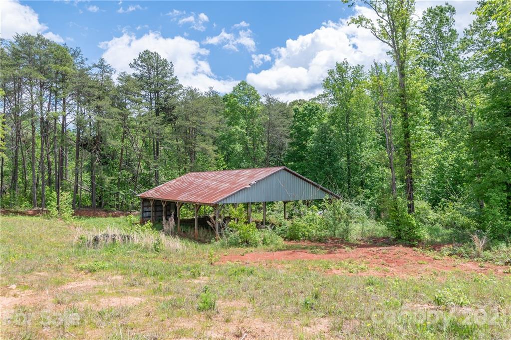 606 Old Stonecutter Road Rutherfordton, NC 28139 - Photo 5 of 48 a backyard of a house with table and chairs