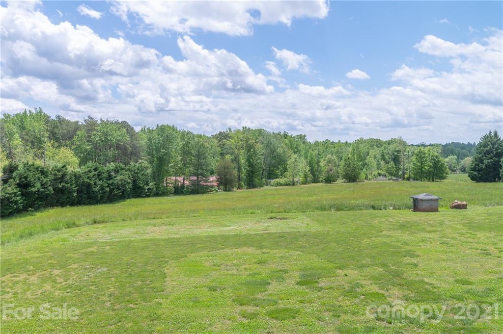 606 Old Stonecutter Road Rutherfordton, NC 28139 - Photo 43 of 48 a view of a green field with wooden fence