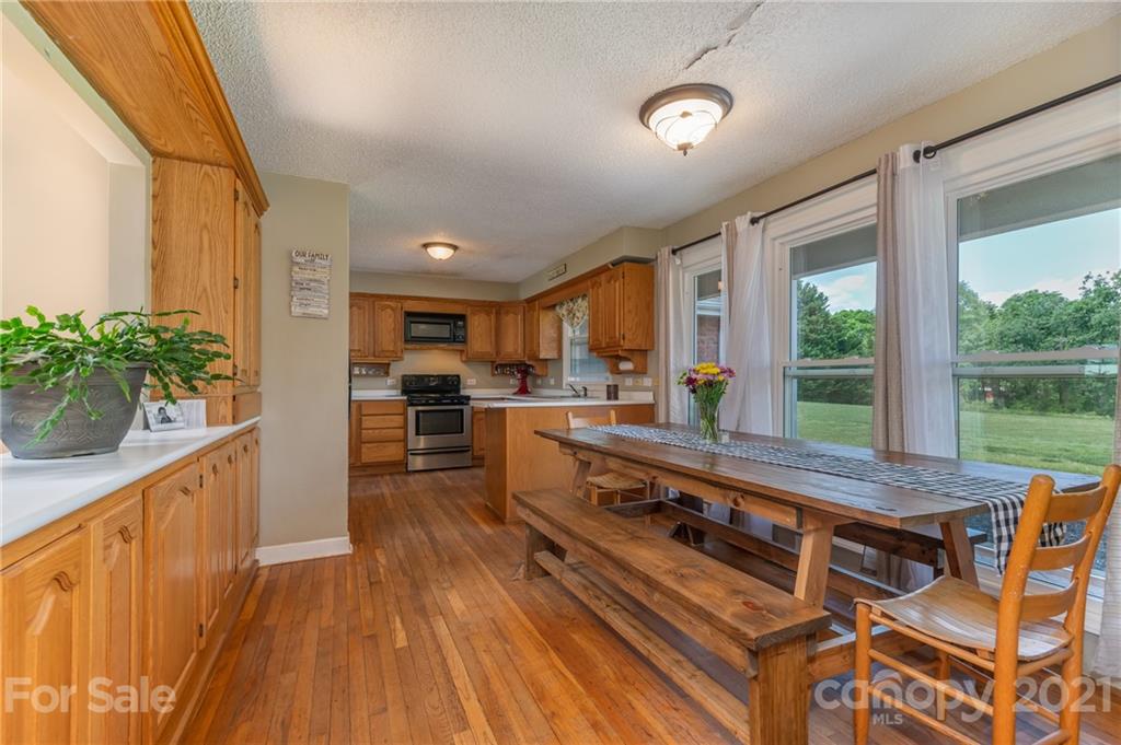 606 Old Stonecutter Road Rutherfordton, NC 28139 - Photo 8 of 48 a large living room with stainless steel appliances granite countertop furniture wooden floor and a large window