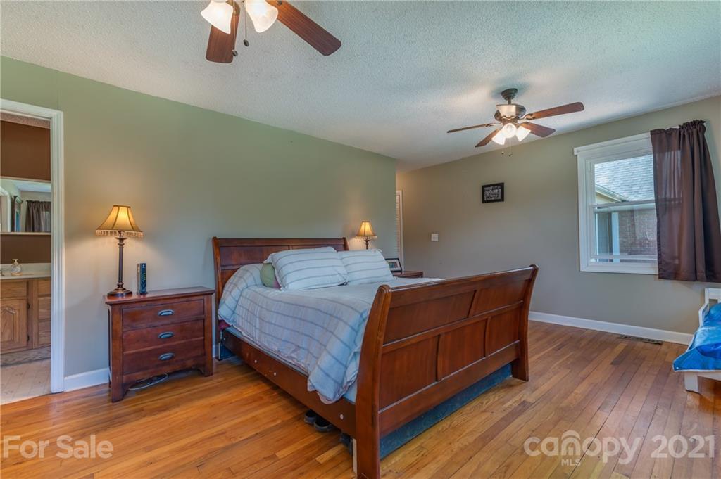 606 Old Stonecutter Road Rutherfordton, NC 28139 - Photo 9 of 48 a bed room with a bed and a chandelier