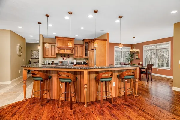 a kitchen with stainless steel appliances granite countertop wooden floors sink and a granite counter tops