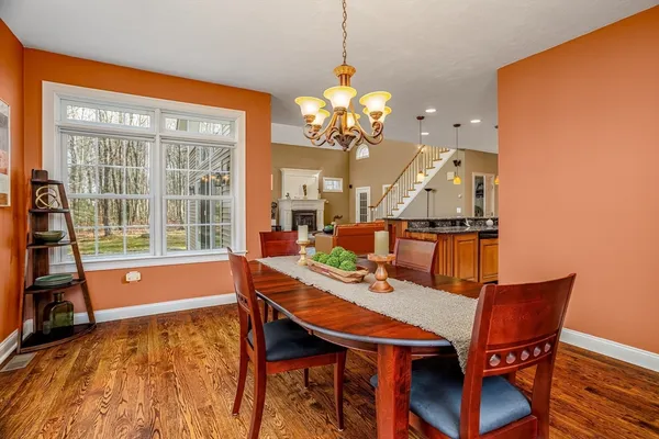a view of a dining room with furniture and a chandelier