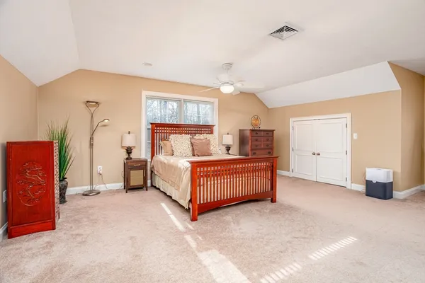 a bedroom with bed and window