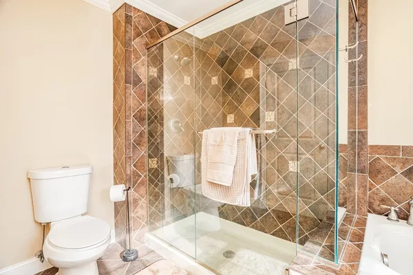 a bathroom with a toilet and shower