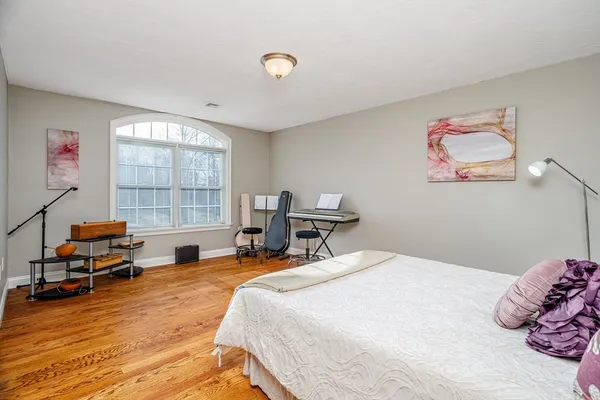 a bedroom with a bed and a large window