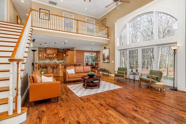 a living room with furniture and wooden floor