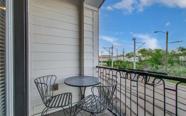 a view of balcony with a table and chairs