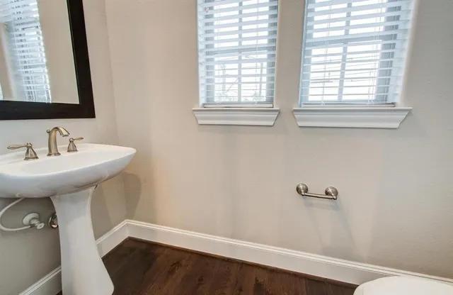 a bathroom with a sink a mirror and a toilet
