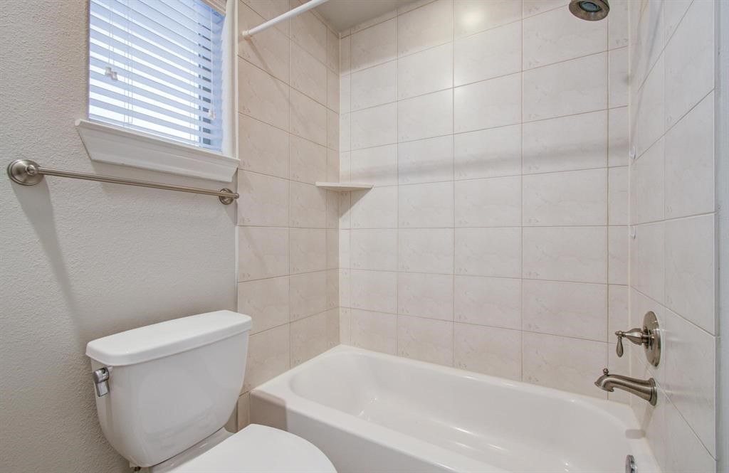 610 Delano Street Houston, TX 77003 - Photo 20 of 36 a white toilet sitting next to a bath tub and a shower