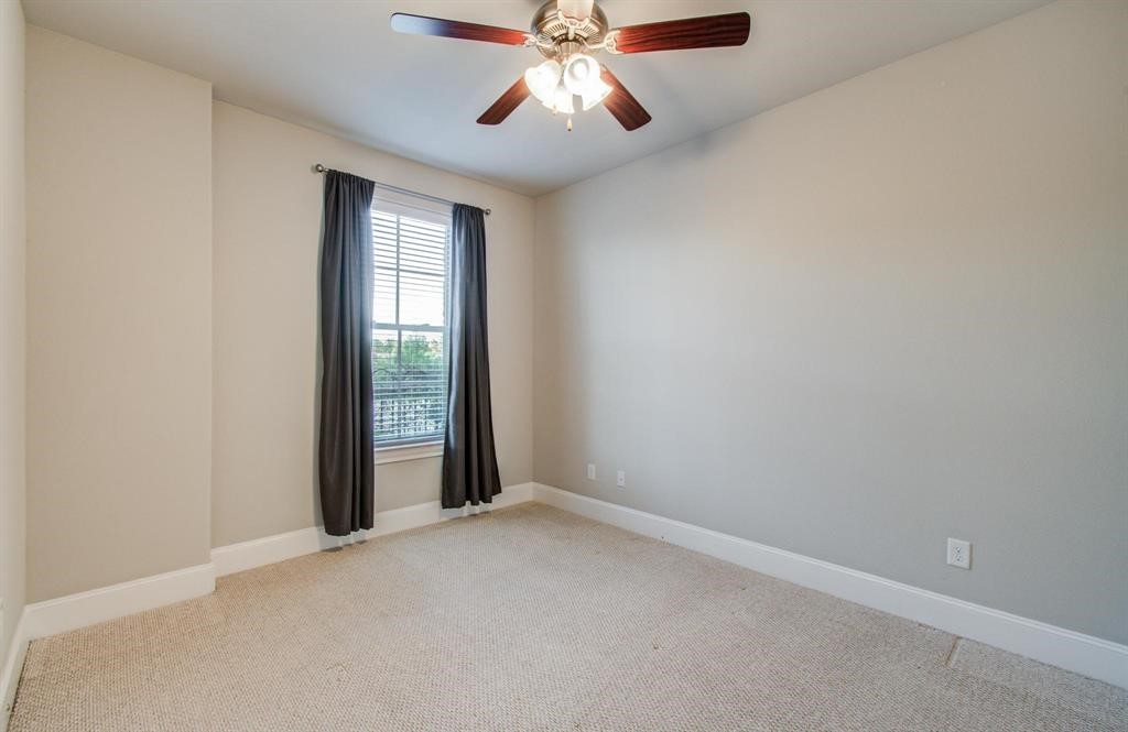 610 Delano Street Houston, TX 77003 - Photo 23 of 36 an empty room with chandelier fan and windows