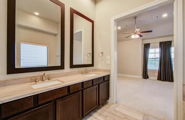 a bathroom with a double vanity sink a large mirror and a shower