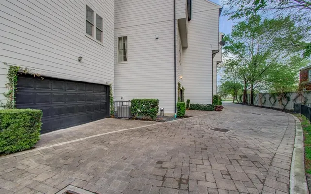 a front view of a house with a yard and a garage