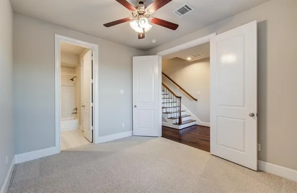 a view of an empty room and a ceiling fan