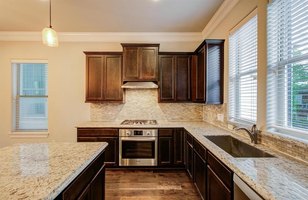610 Delano Street Houston, TX 77003 - Photo 7 of 36 a kitchen with stainless steel appliances granite countertop stove microwave and sink