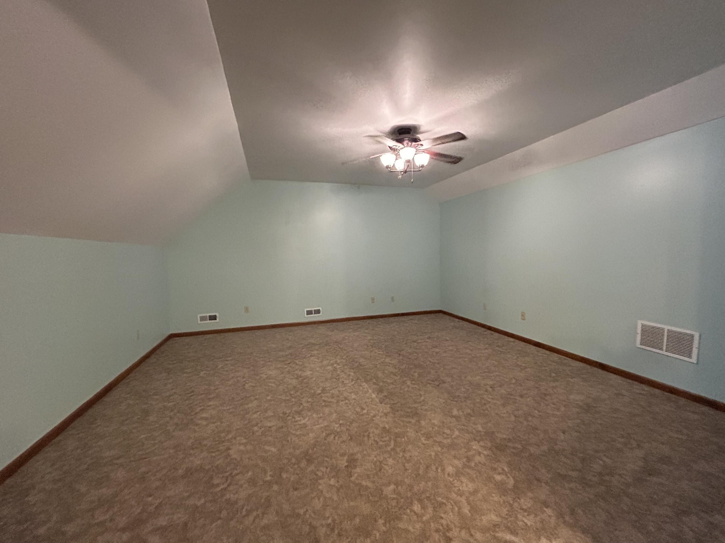8876 North Lilac Street Demotte, IN 46310 - Photo 23 of 23 a view of an empty room with a chandelier fan