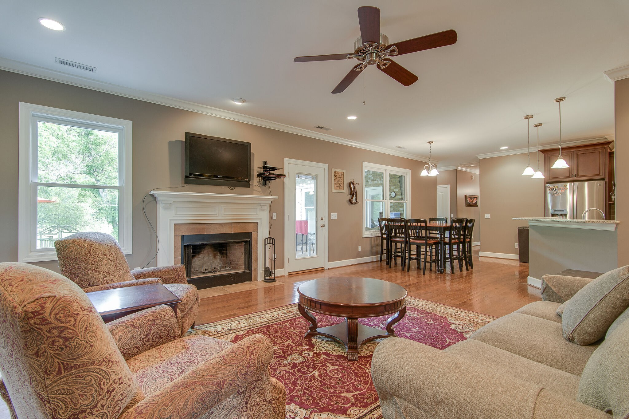 5125 Old Harding Road Franklin, TN 37064 - Photo 12 of 50 a living room with furniture a fireplace and a flat screen tv