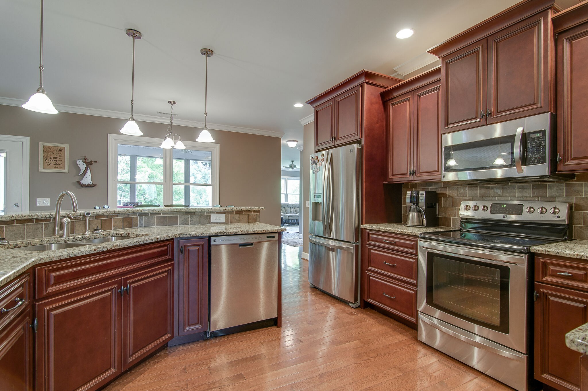 5125 Old Harding Road Franklin, TN 37064 - Photo 16 of 50 a kitchen with stainless steel appliances granite countertop a stove a sink dishwasher a refrigerator and a microwave