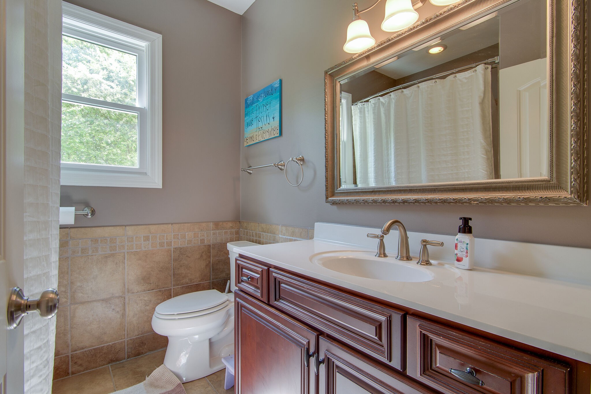5125 Old Harding Road Franklin, TN 37064 - Photo 21 of 50 a bathroom with a sink a toilet a mirror and a window
