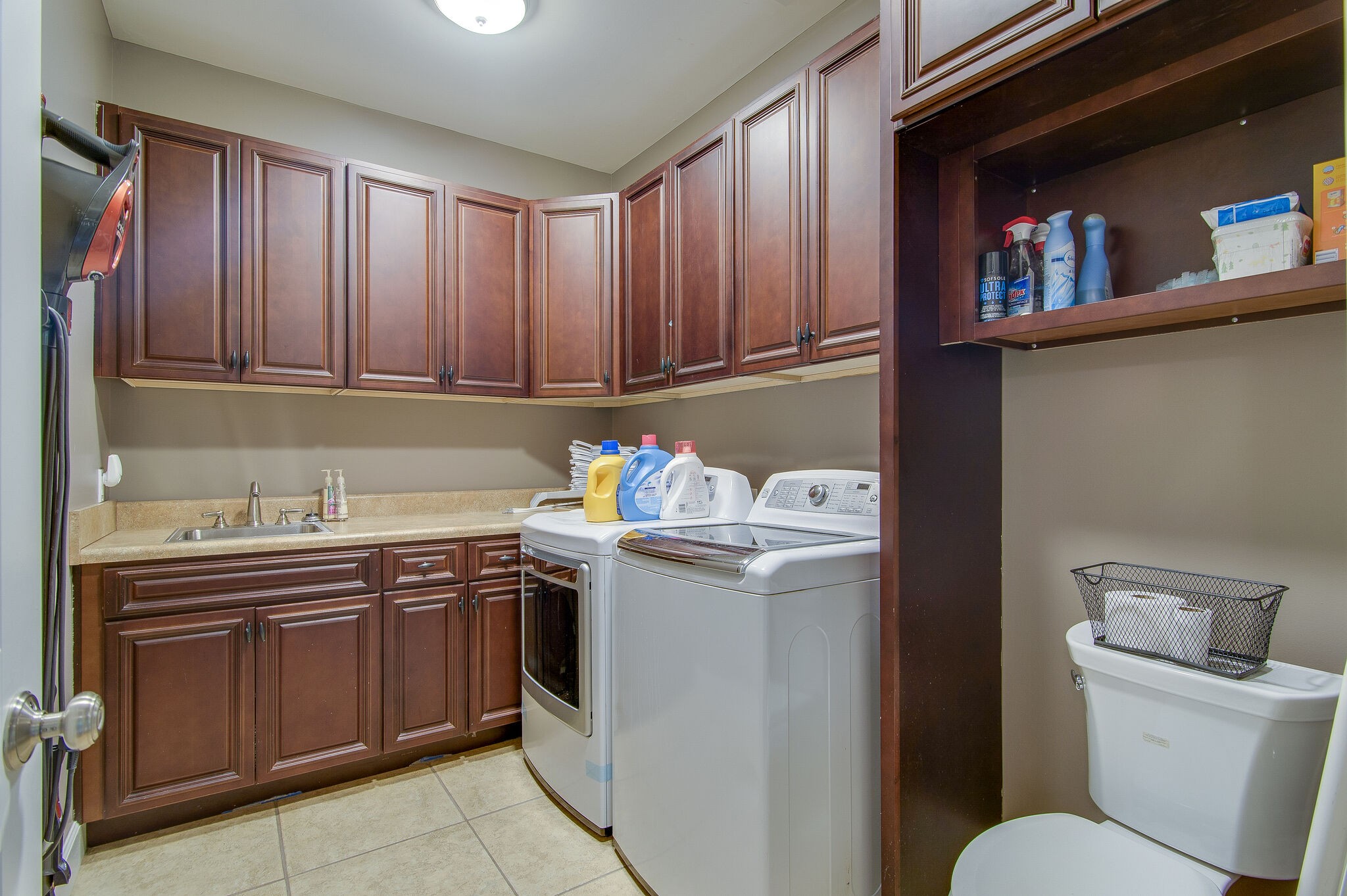 5125 Old Harding Road Franklin, TN 37064 - Photo 26 of 50 a utility room with granite countertop cabinets washer and dryer