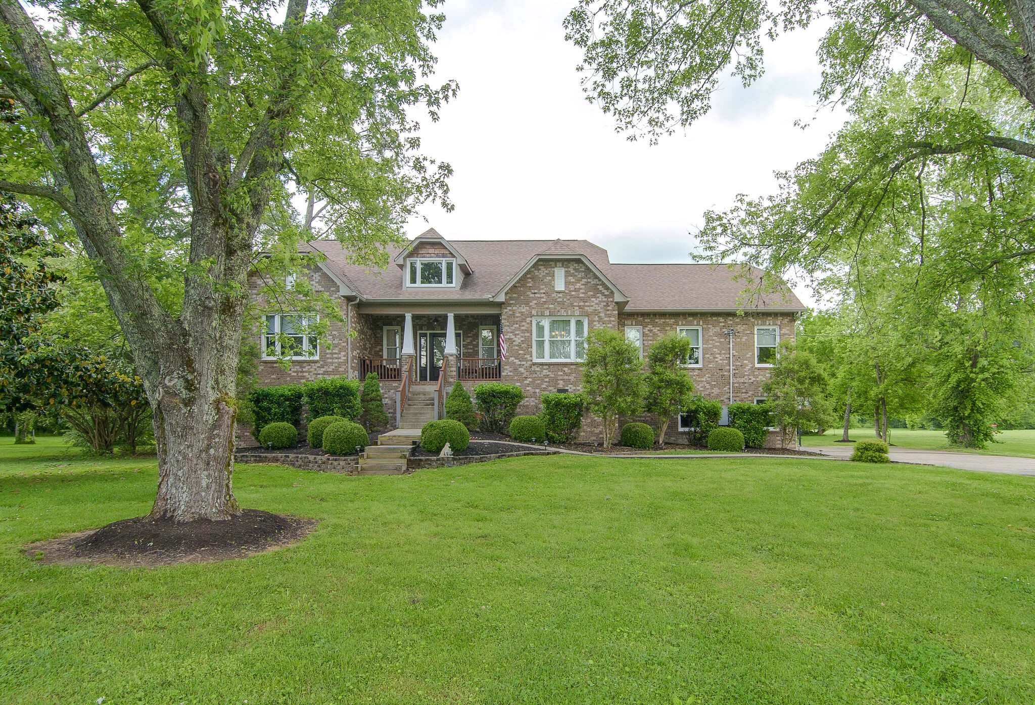 5125 Old Harding Road Franklin, TN 37064 - Photo 3 of 50 a front view of a house with a yard