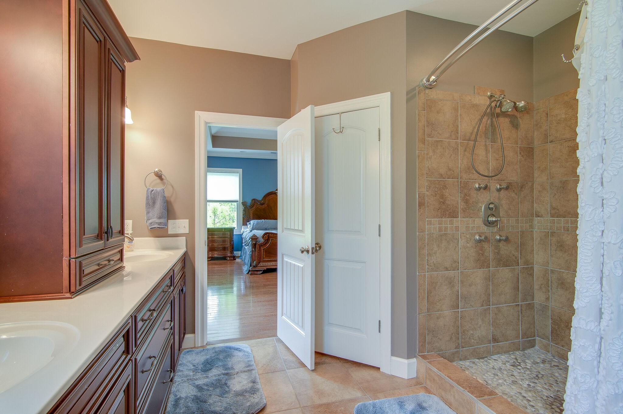 5125 Old Harding Road Franklin, TN 37064 - Photo 31 of 50 a bathroom with a granite countertop shower a sink and a mirror