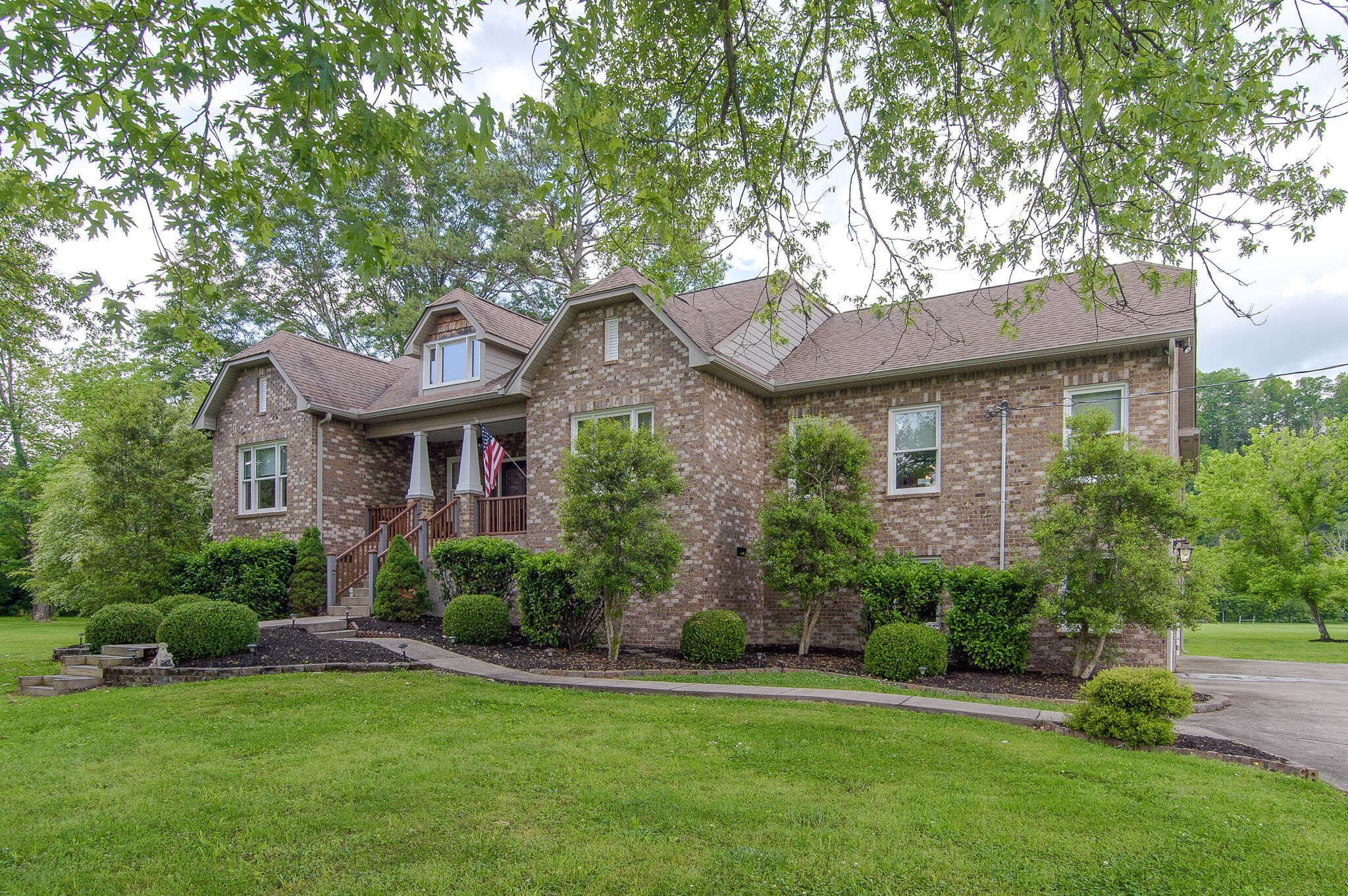 5125 Old Harding Road Franklin, TN 37064 - Photo 5 of 50 a front view of a house with a garden