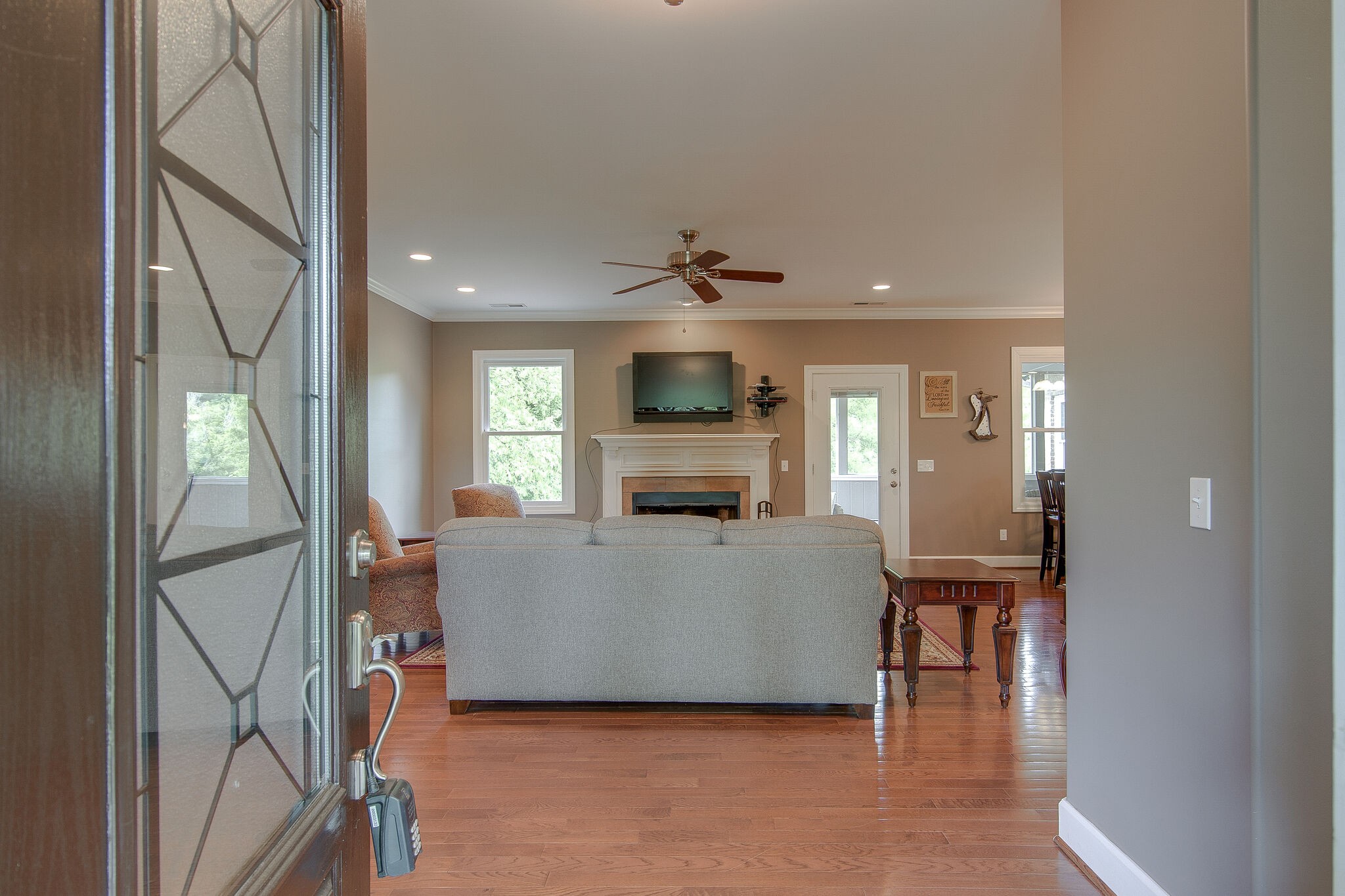 5125 Old Harding Road Franklin, TN 37064 - Photo 9 of 50 a living room with furniture a fireplace and a flat screen tv
