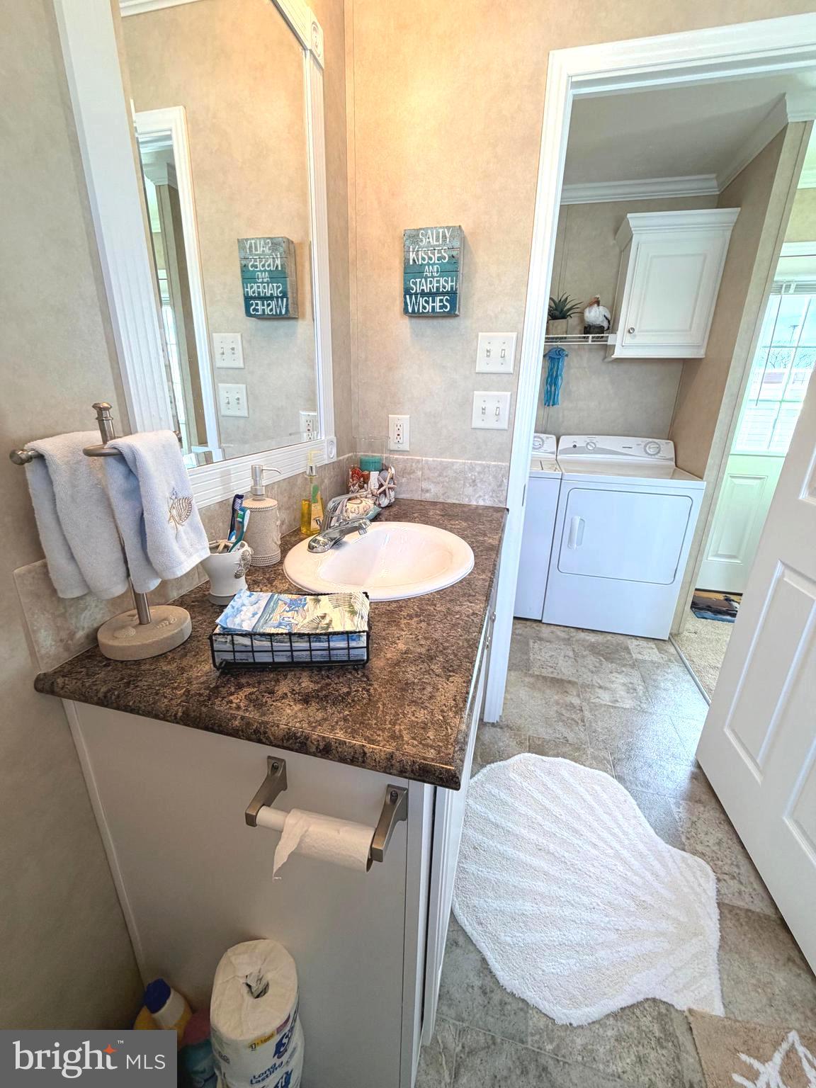 38025 Rabbit Road, Unit 101 Ocean View, DE 19970 - Photo 77 of 112 a bathroom with a granite countertop sink and a mirror