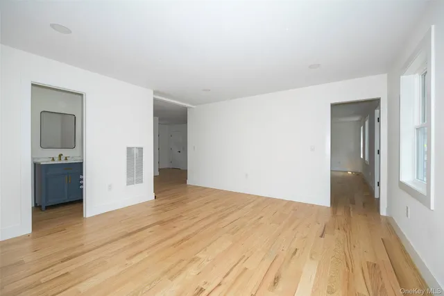 a view of an empty room and wooden floor